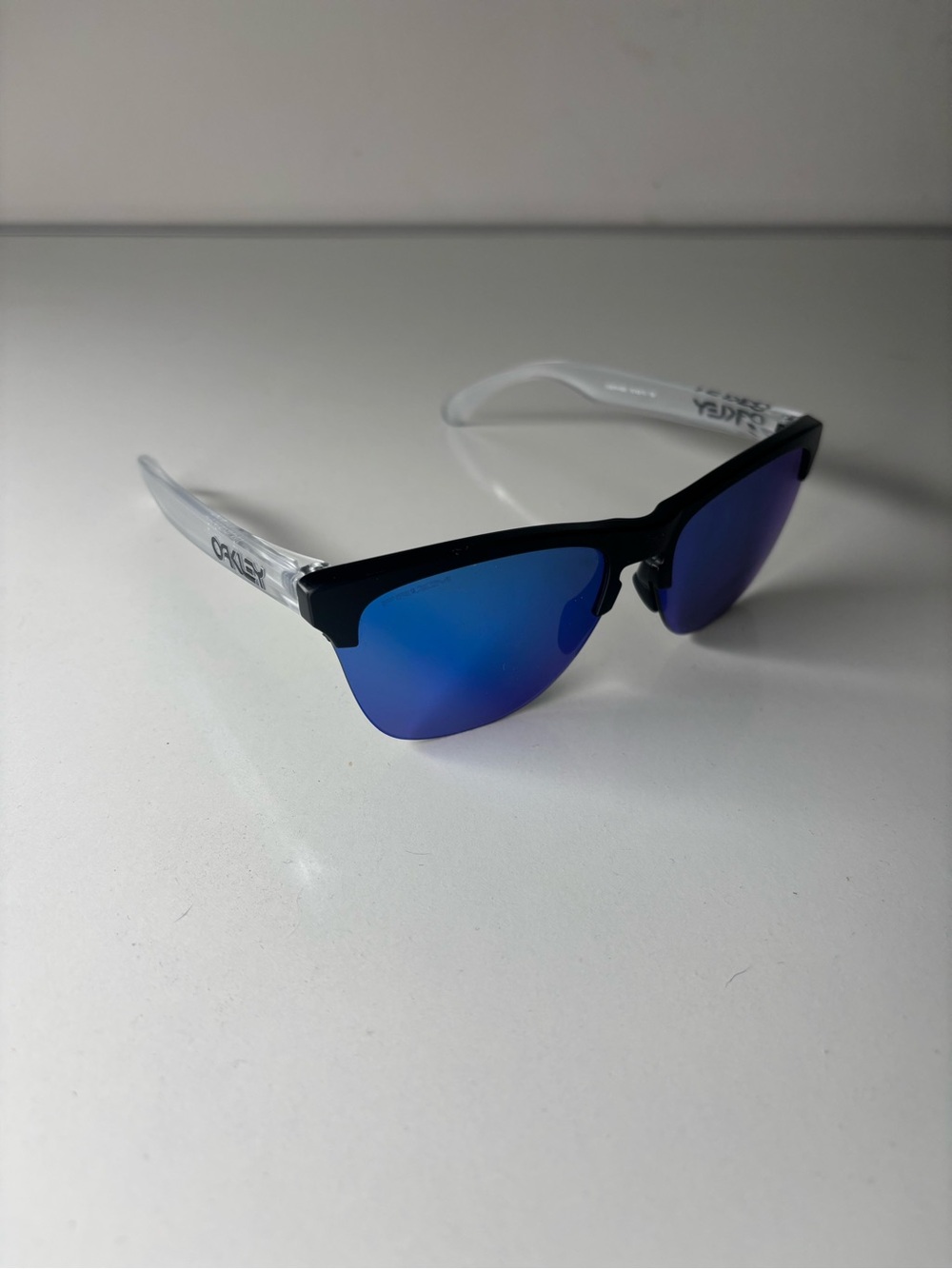 Oakley Sunglasses Black Frame with Blue Mirrored Lenses and Clear Arms